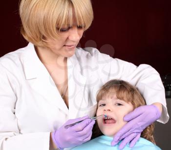 female dentist and little girl patient dental exam
