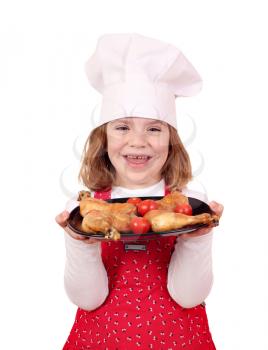 happy little girl cook hold dish with chicken drumstick