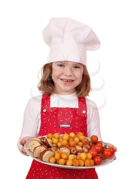 happy little girl cook hold plate with gourmet food