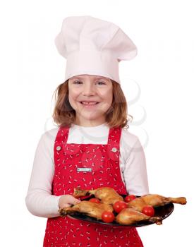 happy little girl cook with delicious chicken drumsticks