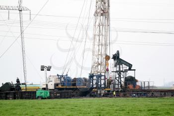 heavy industry oilfield with rig and pump jack