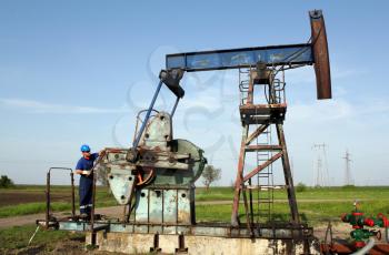 oil worker working on pump jack