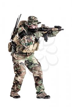 Special forces United States in Camouflage Uniforms studio shot. Holding weapons, wearing jungle hat, shooting on the move, attacking enemy. Studio shot isolated