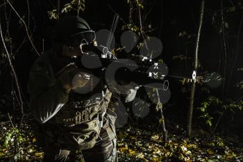 United states Marine Corps special operations command Marine Special Operator also known as Marsoc raider aiming weapons in the greenery at nighttime