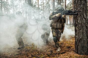 Norwegian Rapid reaction special forces FSK soldiers in field uniforms in action in the forest fog