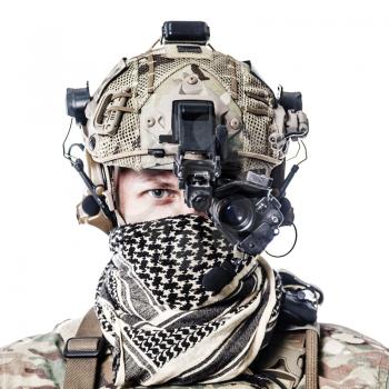 Army Ranger in field Uniforms with weapon, plate carrier and combat helmet are on, his face closed by Shemagh Kufiya scarf. Studio shot