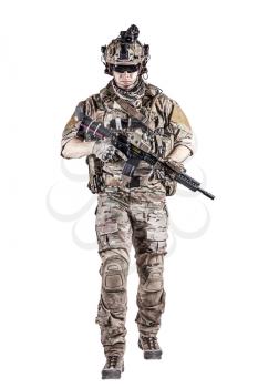 US Army rangers in combat uniforms with his shirt sleeves rolled up, in helmet, eyewear and night vision goggles moving walking towards camera. Studio shot, white background