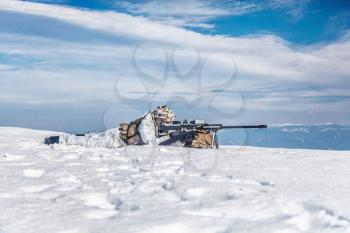 Army soldier with Sniper rifle in action in the Arctic. He lies in the snow desert, suffering from extreme cold, but waiting as long as enemies appear to kill them