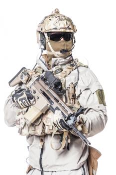 Army soldier in Protective Combat Uniform holding Special Operations Forces Combat Assault Rifle. Mag recovery pouch, chest rig, military boots. Studio shot, isolated on white background