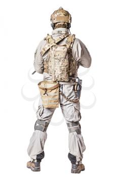 Army soldier in Protective Combat Uniform holding Special Operations Forces Combat Assault Rifle. Knee pads, mag recovery pouch, chest rig, military boots. Studio shot, isolated on white, back view