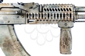 Close-up shot of Kalashnikov rifle fore-end with rails, automatic weapons isolated on white background. Gun fore end is painted desert camouflage
