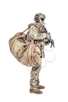 Soldier standing with duffle gym bag studio shot