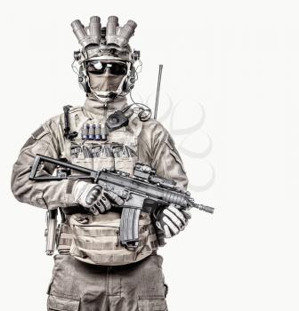 Special operations forces soldier, counter terrorist squad fighter, military mercenary in mask and night vision device, armed with short barrel service rifle studio portrait isolated white background