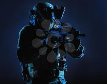 Army special operations squad soldier, police counter terrorism assault team member, security service rifleman in mask, helmet with headset and night vision device, armed short barrel service rifle
