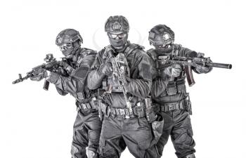 Police special operations tactical team, special security operations group fighters in black blank uniforms and full ammunition, armed with assault rifles, studio shoot, isolated on white background