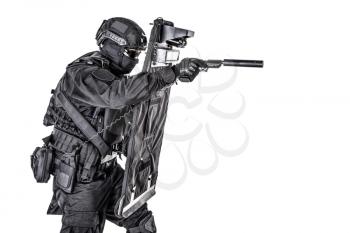 Police special operations and counter-terrorism team, SWAT officer in black uniform, mask and helmet, hiding behind ballistic shield and aiming with pistol, studio shoot, isolated on white background