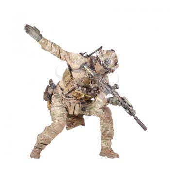 Army soldier, modern combatant, fireteam sergeant in battle uniform and helmet, armed with service rifle, duck under enemy fire, giving follow me arm signal studio shoot isolated on white background