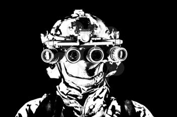 Modern army special forces soldier, anti terrorist squad fighter, elite commando warrior wearing mask, using four lenses night vision goggles in low light conditions, studio shoot on black background