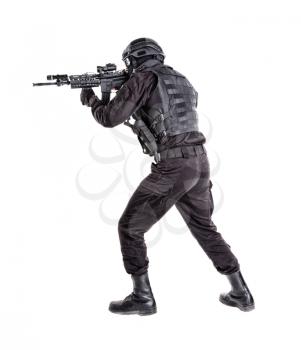 Police anti terrorism squad fighter, SWAT team shooter ready for fight, moving forward with wariness, keeping weapon ready for shoot, aiming service rifle studio shoot isolated on white background