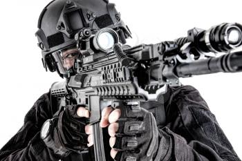 Police special operations fighter, quick reaction group shooter searching targets to shot, observing territory, aiming assault rifle with optical sight, close up studio portrait isolated on white