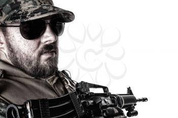 Studio shot of United States Marine with rifle weapons in uniforms turning around. Military equipment, army helmet, black glasses, tactical gloves. Isolated on white, weapons, army, patriotism concept