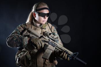 Studio shot of United States Marine with rifle weapons in uniforms. Military equipment, army helmet, combat boots, tactical gloves. Isolated on black, weapons, army, patriotism concept