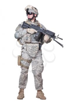Full length portrait of equipped US army soldier in camouflage uniform, helmet and body armor standing with light machine gun in hands isolated on white background Armed marine infantryman studio shot