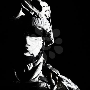 Close up portrait of modern infantry soldier, active army fighter, military mercenary in helmet, face hidden with balaclava and glasses high contrast, cropped on black background. Hybrid war concept