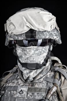 Close up portrait of marine raider, elite army squad member, military company mercenary in combat helmet, pixel camo uniform, protected with balaclava and glasses face studio shot on black background