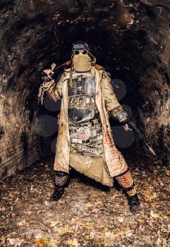 Survived in nuclear disaster and living in catacombs or city underground tunnels human creature, wearing rags and handmade lamellar body armor, hiding face behind mask, armed with pistol and machete