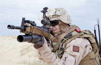 US marine aiming a gun with grenade launcher