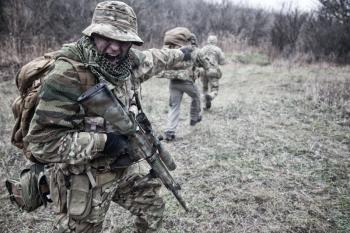 Commandos tactical group commander, army special forces squad leader in camo uniform, armed assault rifle, pointing on enemy location, showing attack or moving direction, screaming orders to comrades