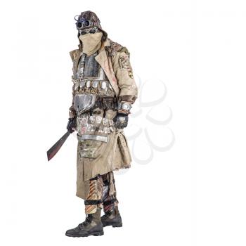 Scary post apocalyptic survivor in handmade armored clothes, armed with machete, dangerous creature with face hidden behind mask and glasses, in rags, standing with cold weapon in hand studio shoot