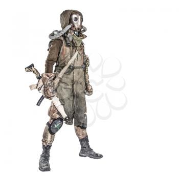 Survivor inhabitant of contaminated by nuclear catastrophe or dangerous chemical pollution world, in tatters and gas mask, standing with handmade firearm gun, isolated on white background studio shoot