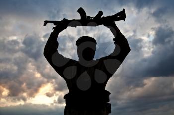 Silhouette of muslim militant with rifle