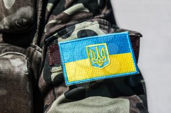 military badge of ukrainian army with trident and yellow-blue flag