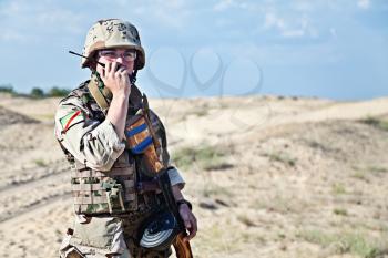 iraqi soldier in the desert talking portable radio station