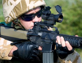 British soldier in camouflage uniform in action