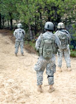 us soldiers with assault rifles on patrol