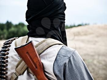 Muslim rebel with automatic rifle and machine-gun belt
