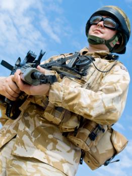 British Royal Commando in desert uniform holding his rifle