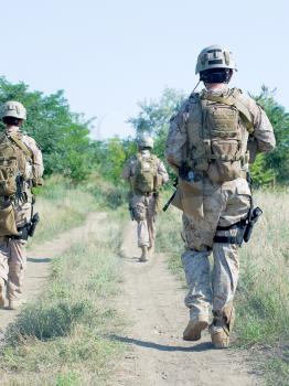us soldiers with assault rifles on patrol
