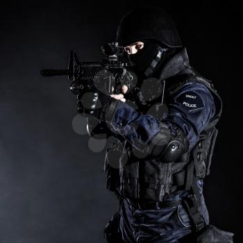 Special weapons and tactics (SWAT) team officer on black background