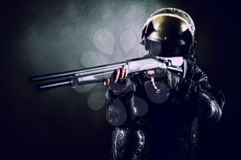 Spec ops soldier on black background with shotgun
