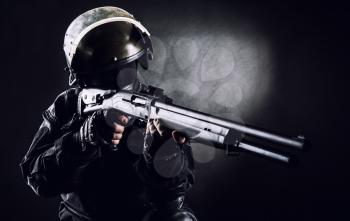 Spec ops soldier on black background with shotgun