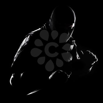 Contour shot of spec ops soldier with knife on black background