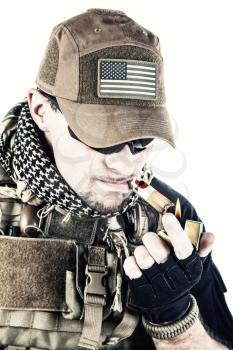 Studio shot of private military contractor PMC smoking a cigar