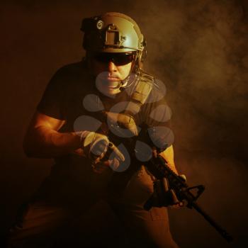 Private military contractor PMC with assault rifle on dark background