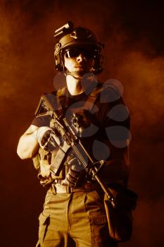 Private military contractor PMC with assault rifle on dark background
