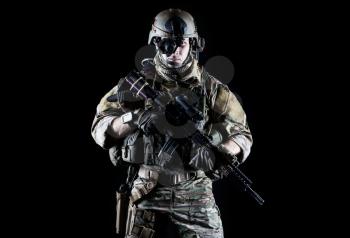 United States Army ranger with assault rifle on dark background